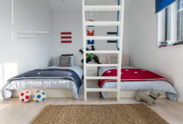 Children's bedroom with a red and a blue bed, a small window and white wooden stairs for the upper gallery.