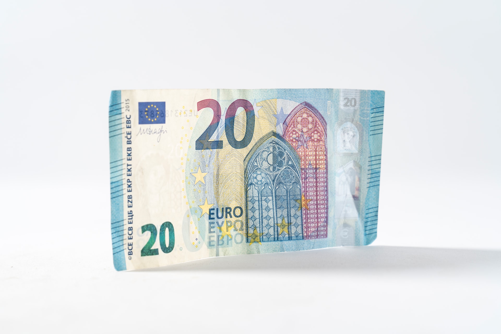 A blue bill of 20 euro on a white background.