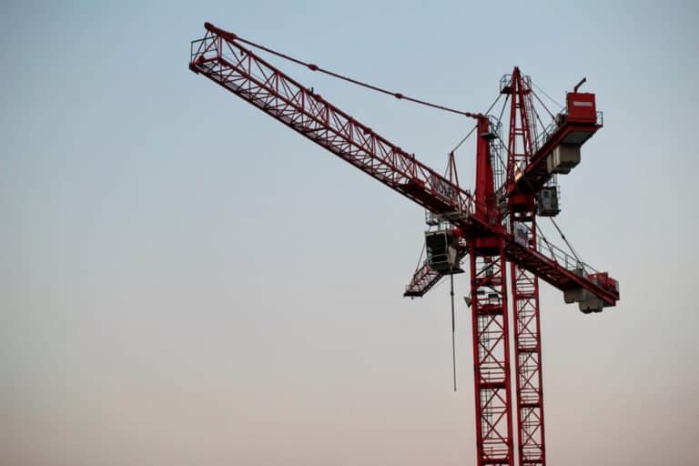 Two red cranes during the golden hour.