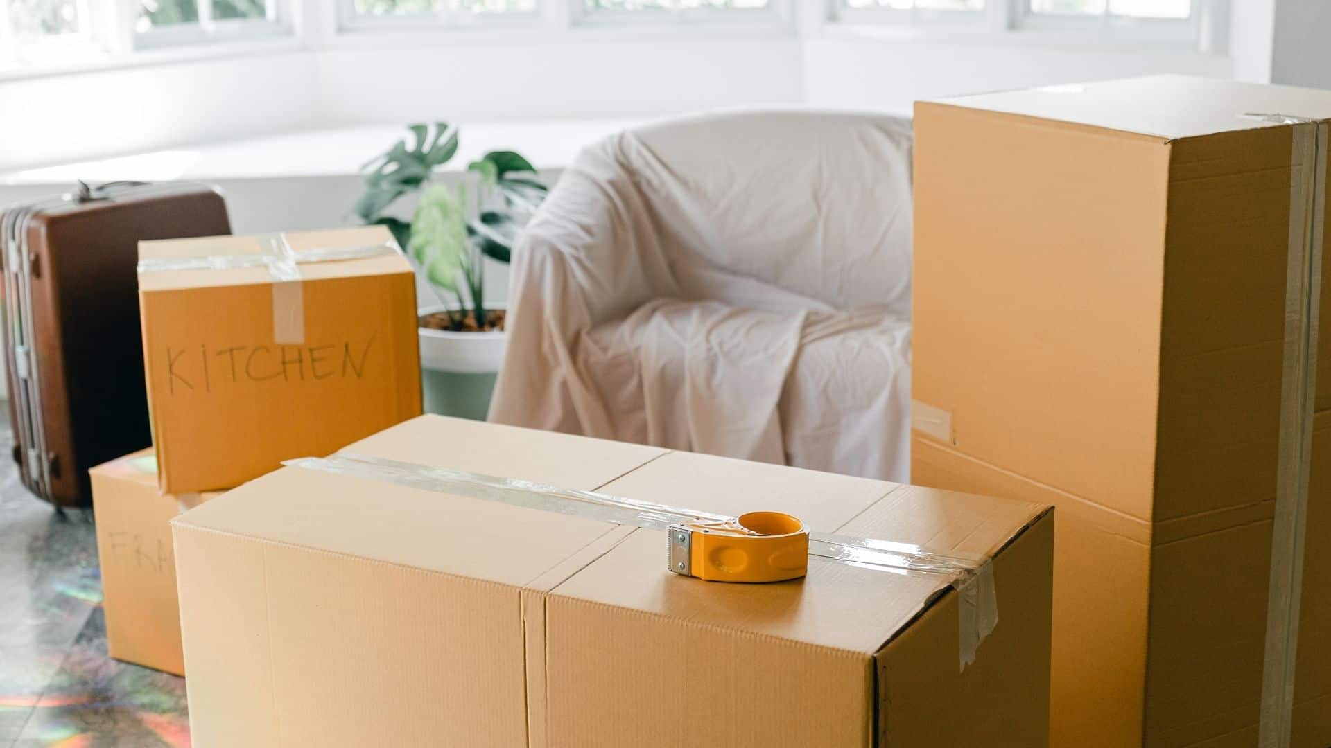 Three boxes in the middle of the living room, ready to load for moving.