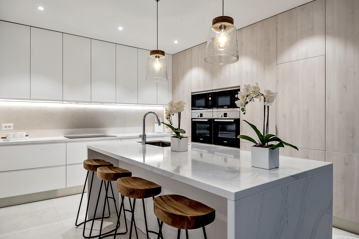 A minimalist white kitchen with smart gadgets.