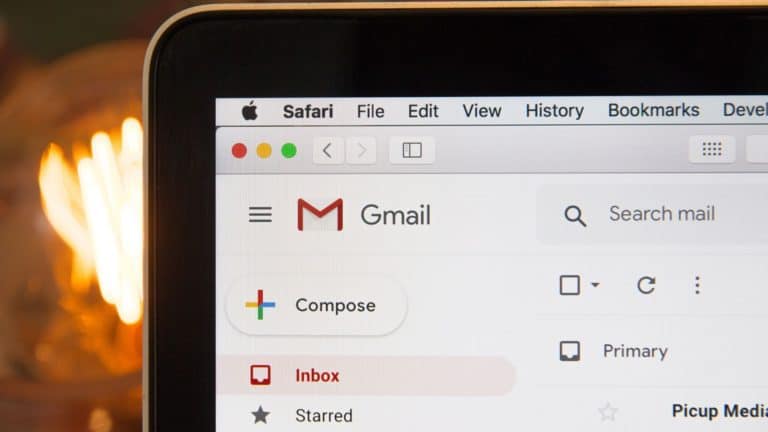 The upper left corner of the laptop screen showing the Gmail logo.