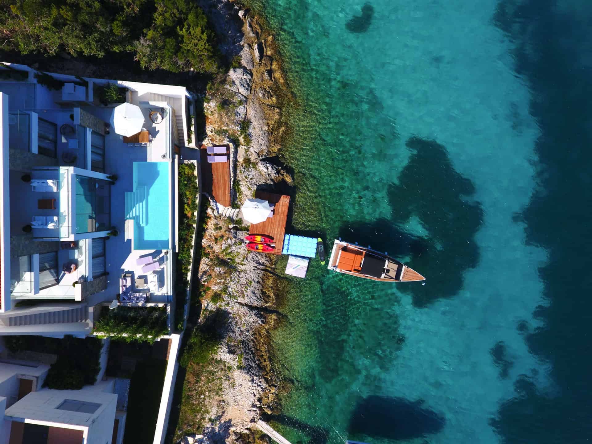 The yacht and the villa with a poll on the image taken from above.